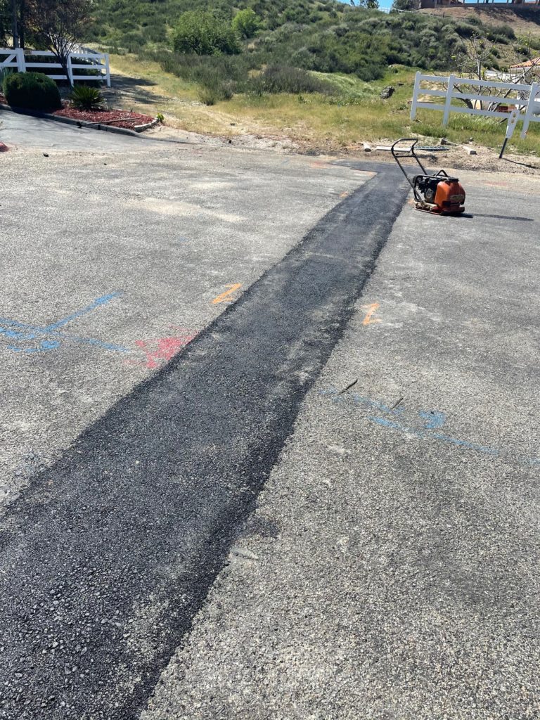 Customer reading Perris asphalt company reviews of Black Diamond Asphalt, highlighting positive feedback on residential and commercial paving projects